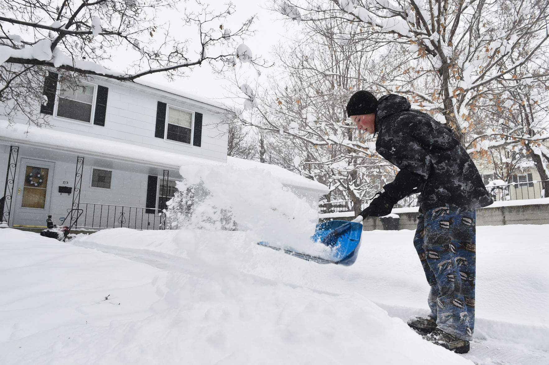 Arleigh Berner shovels snow